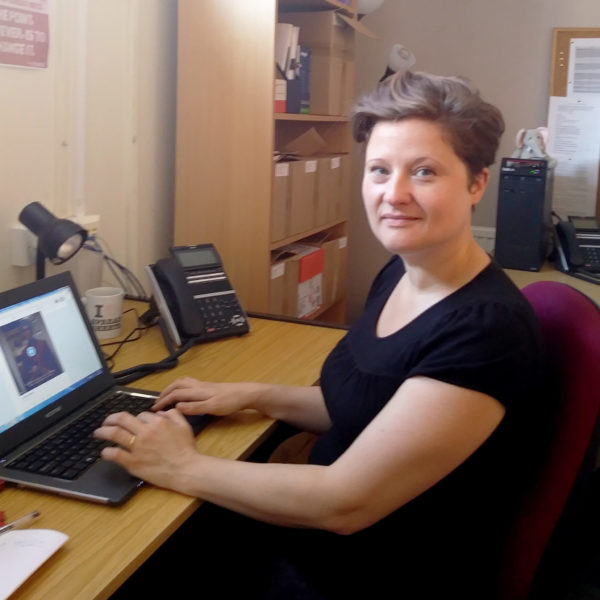 Jennie Bibbings sitting at a desk with a laptop