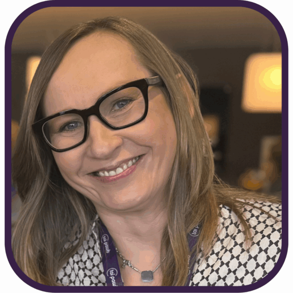 Headshot of Alicja, Tai Pawb CEO. She is wearing black glasses and has blonde hair past her shoulders