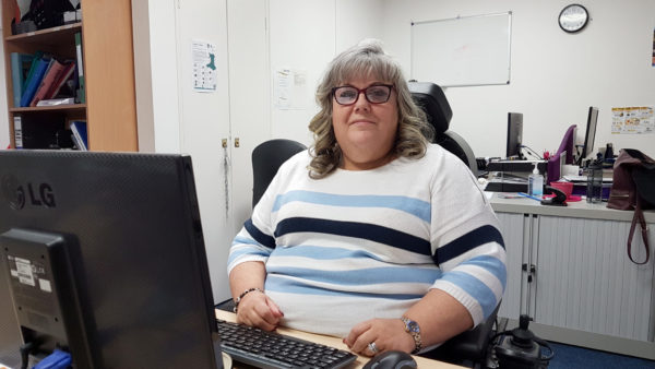 Jill sitting at her desk