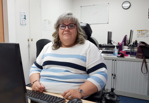 Jill sitting at her desk